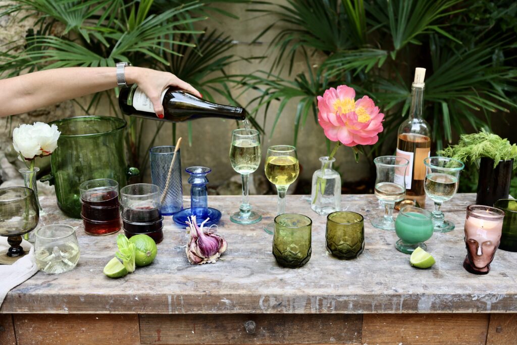 la-soufflerie-recycled-glassware-on-table-with-hand-pouring-red-wine