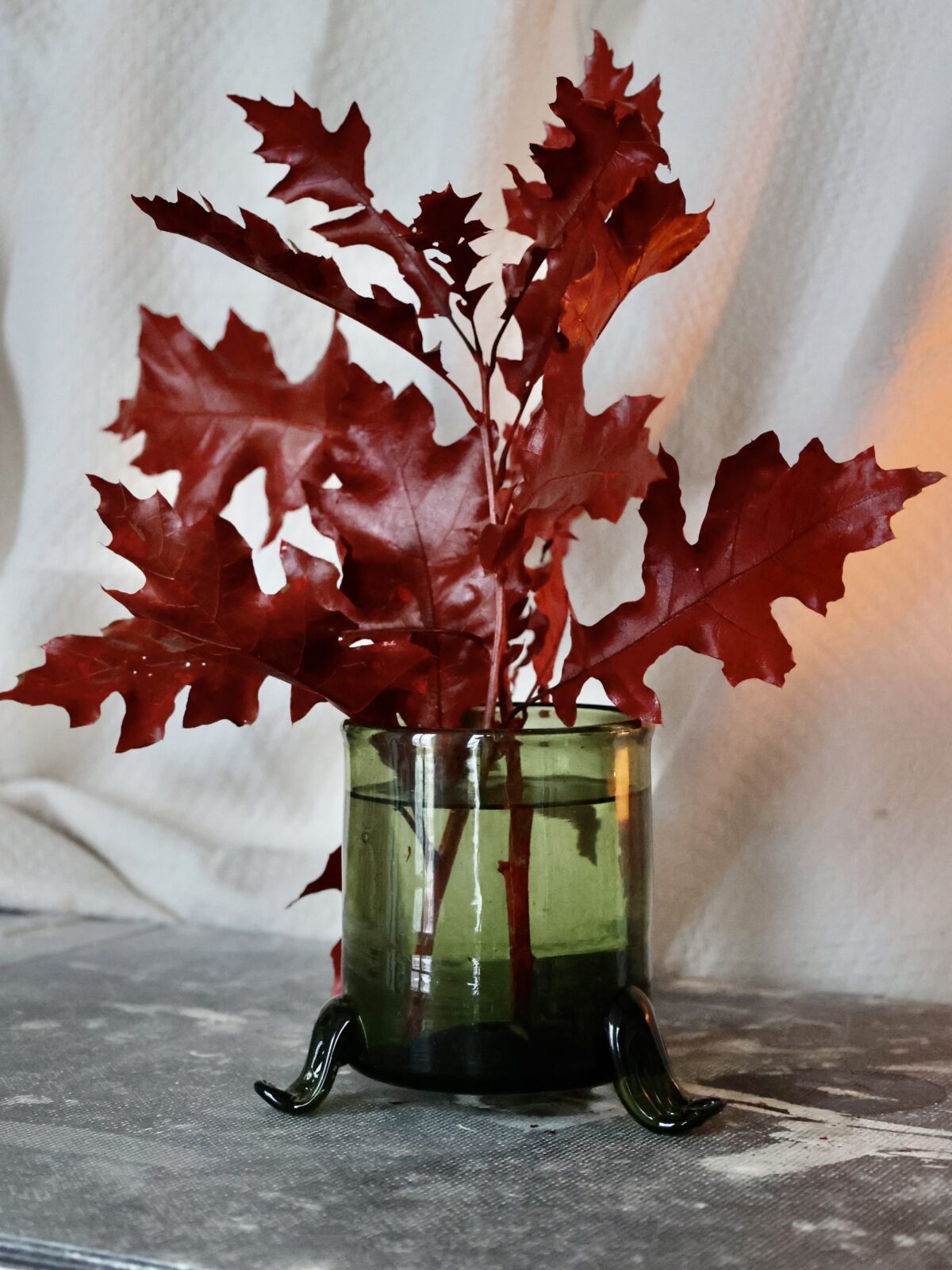 hurricane-vase-with-3-feet-vert-fumé-mouth-blown-recycled-glass